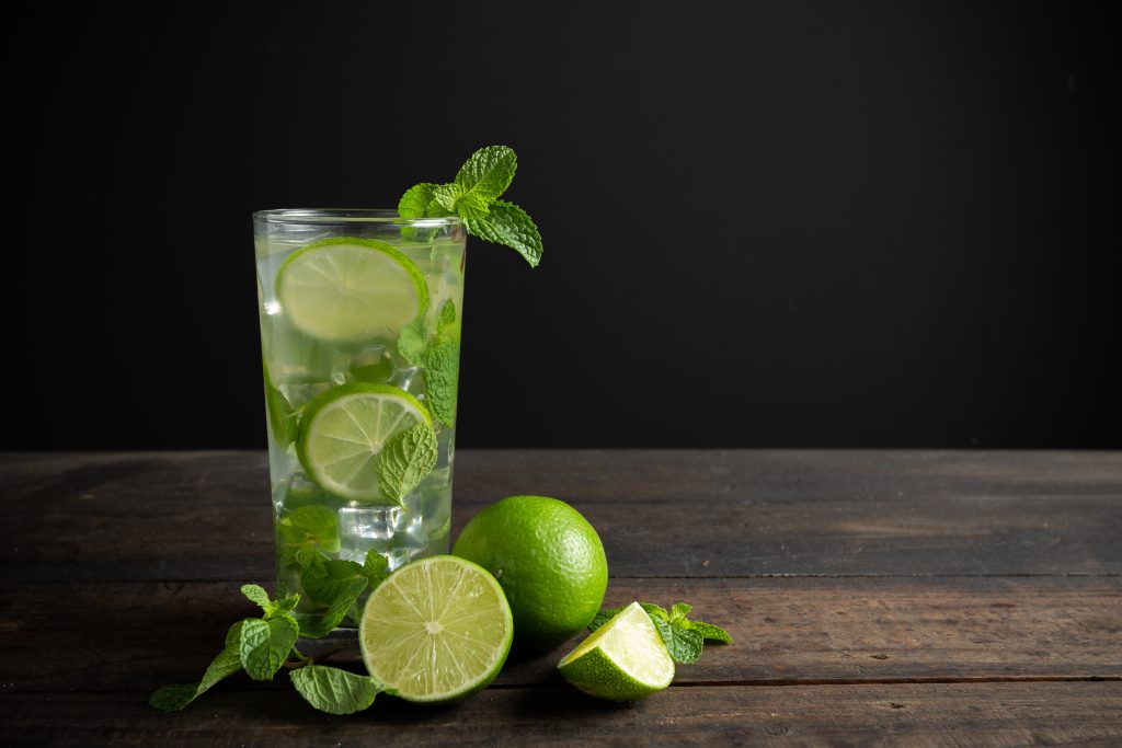 Mojito Drink With Lime, Lemon And Mint On Wooden Table.