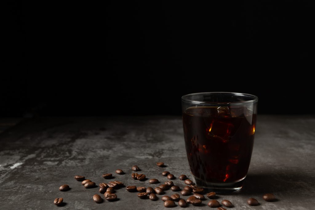 Ice Black Coffee In A Glass On The Wooden Table.